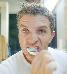 Man brushes teeth