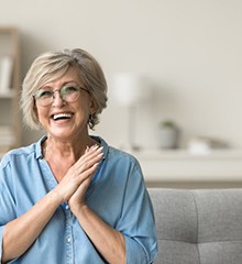 a woman smiling while on the couch