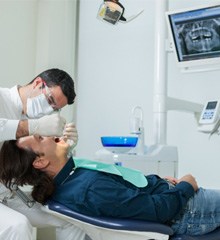 Implant dentist examining X-ray 