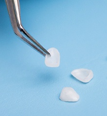 Close up of veneers in Farmington on blue background