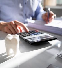 Tooth next to a man doing calculations