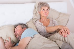 woman upset with husband snoring