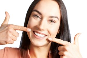 woman pointing to her teeth