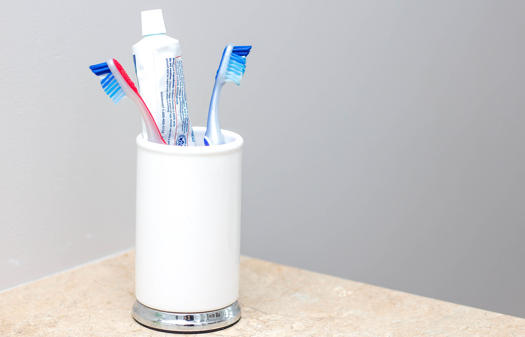 toothbrush holder with toothbrushes and toothpaste