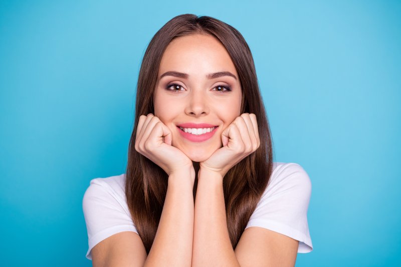 A woman smiling with her new dental veneers